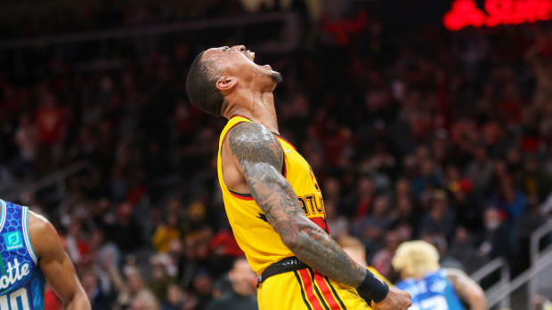 Hawks forward John Collins celebrates after a dunk.